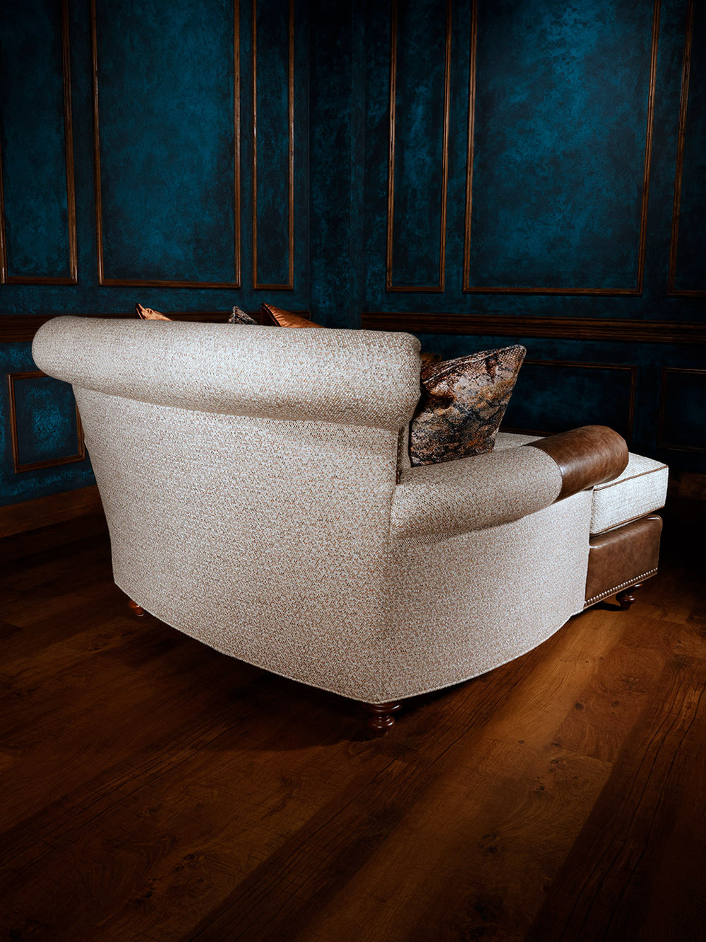 rear view of white fabric and brown leather chaise lounge