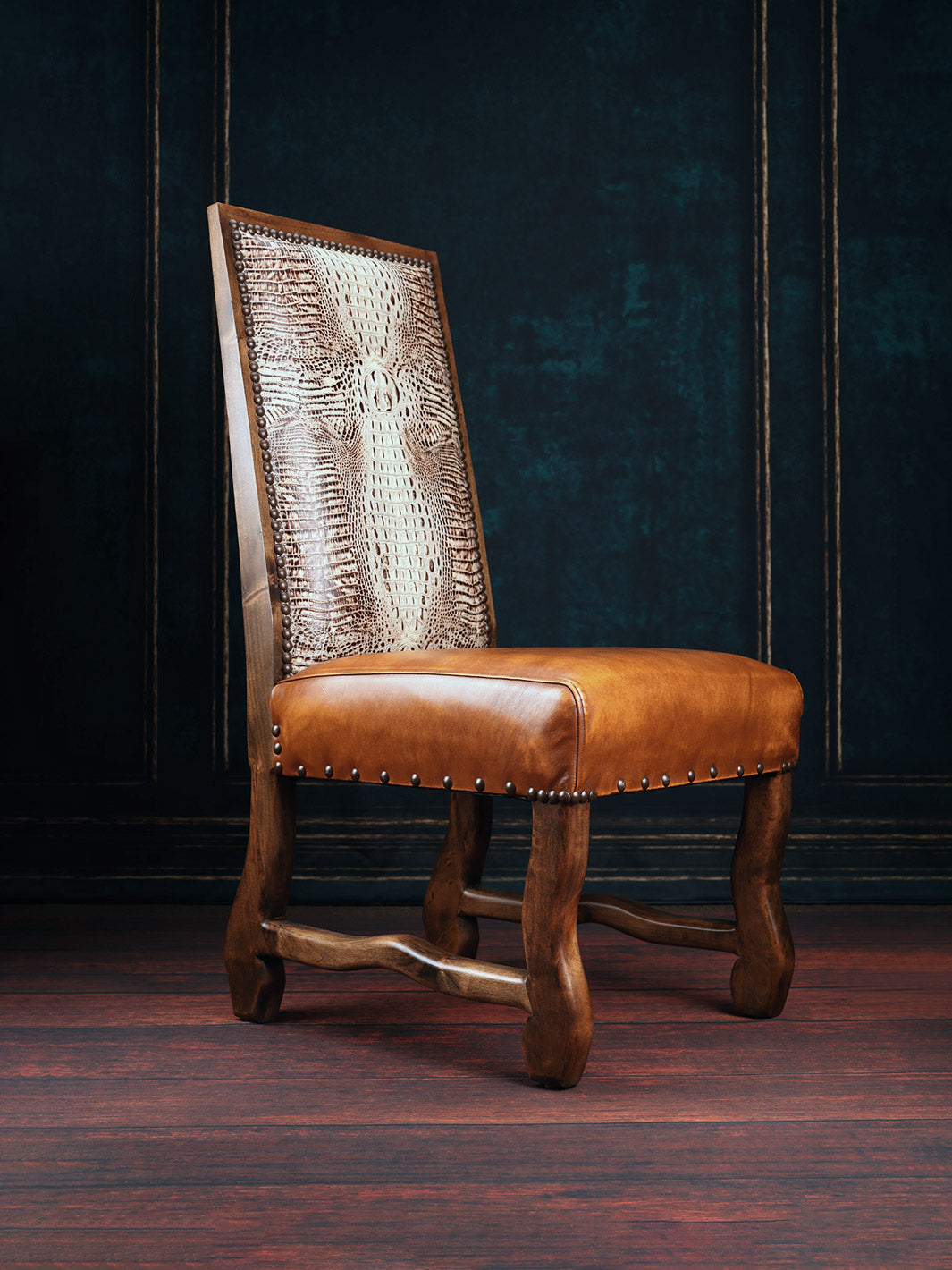 A brown leather dining chair with a crocodile patterned backrest, featuring a smooth leather seat and alder wood frame.
