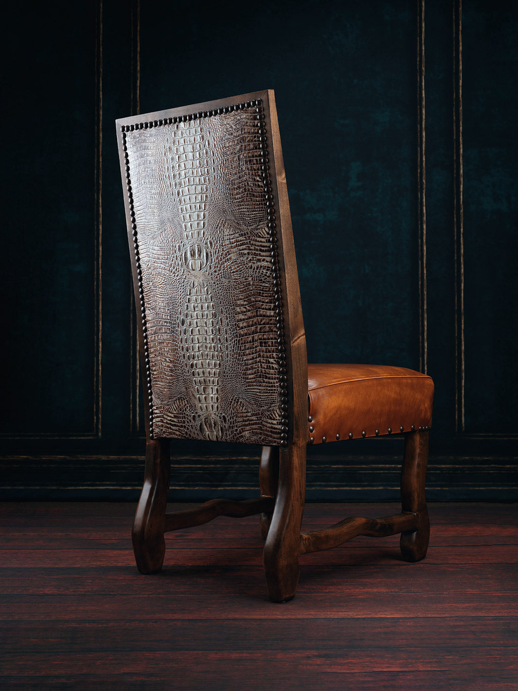 A brown leather dining chair with a textured backrest and a smooth seat, featuring a dark wood frame and White Gator backing.