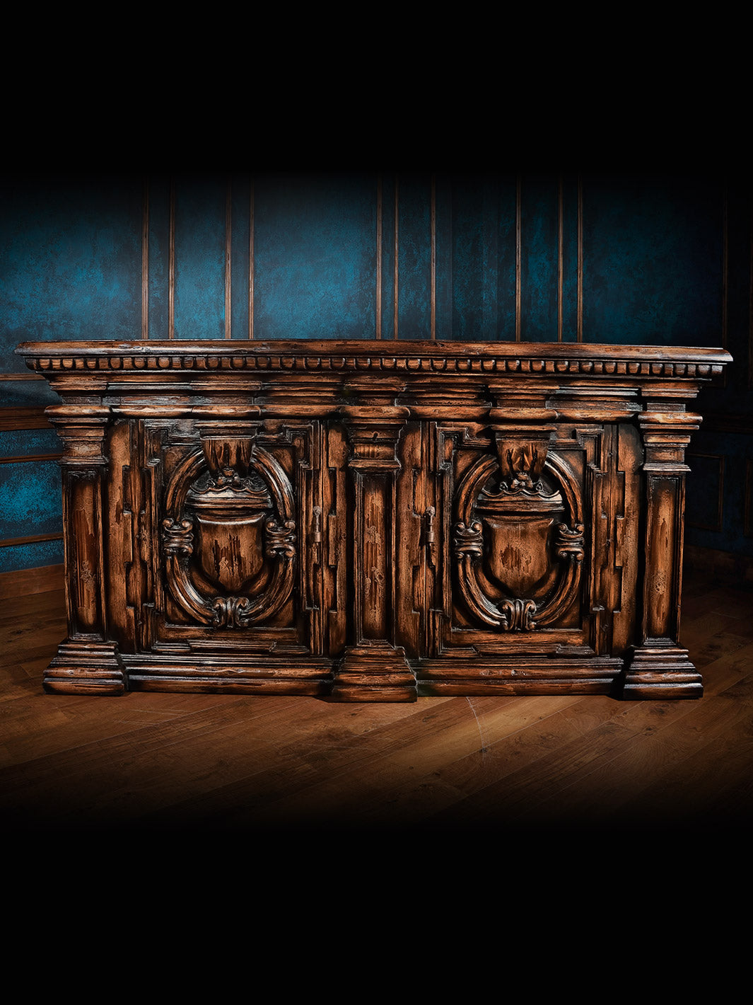 A wooden buffet cabinet with a dark finish, featuring an intricate design with doors and a high shelf.