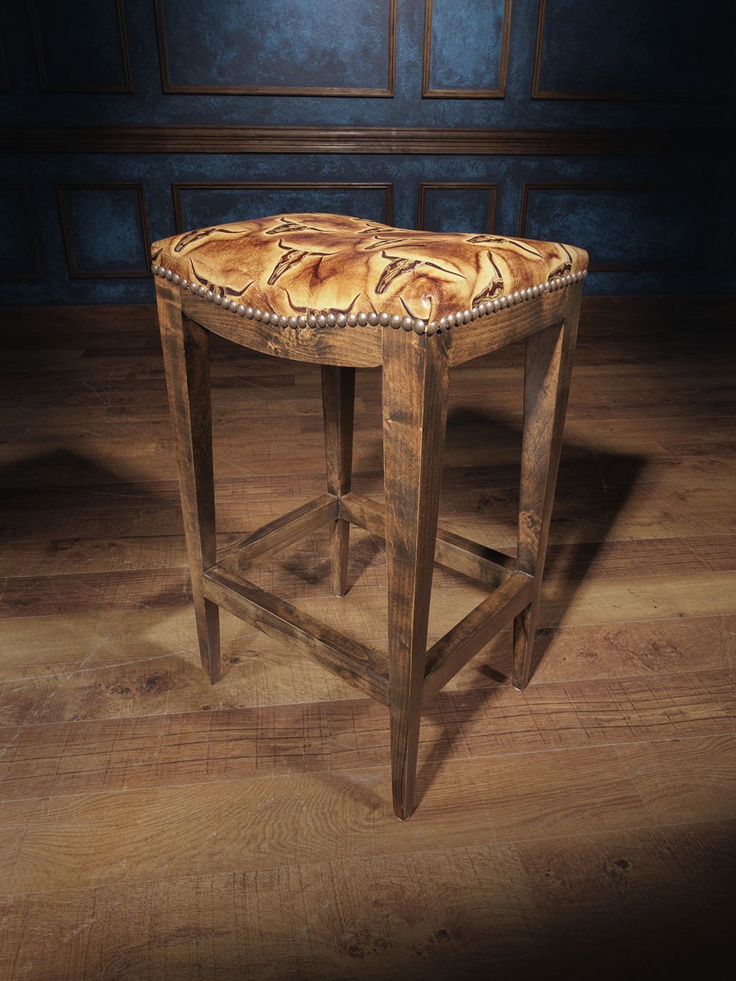A saddle stool with a brown wooden frame and an upholstered seat featuring a geometric pattern, likely designed with themes from the Old West.