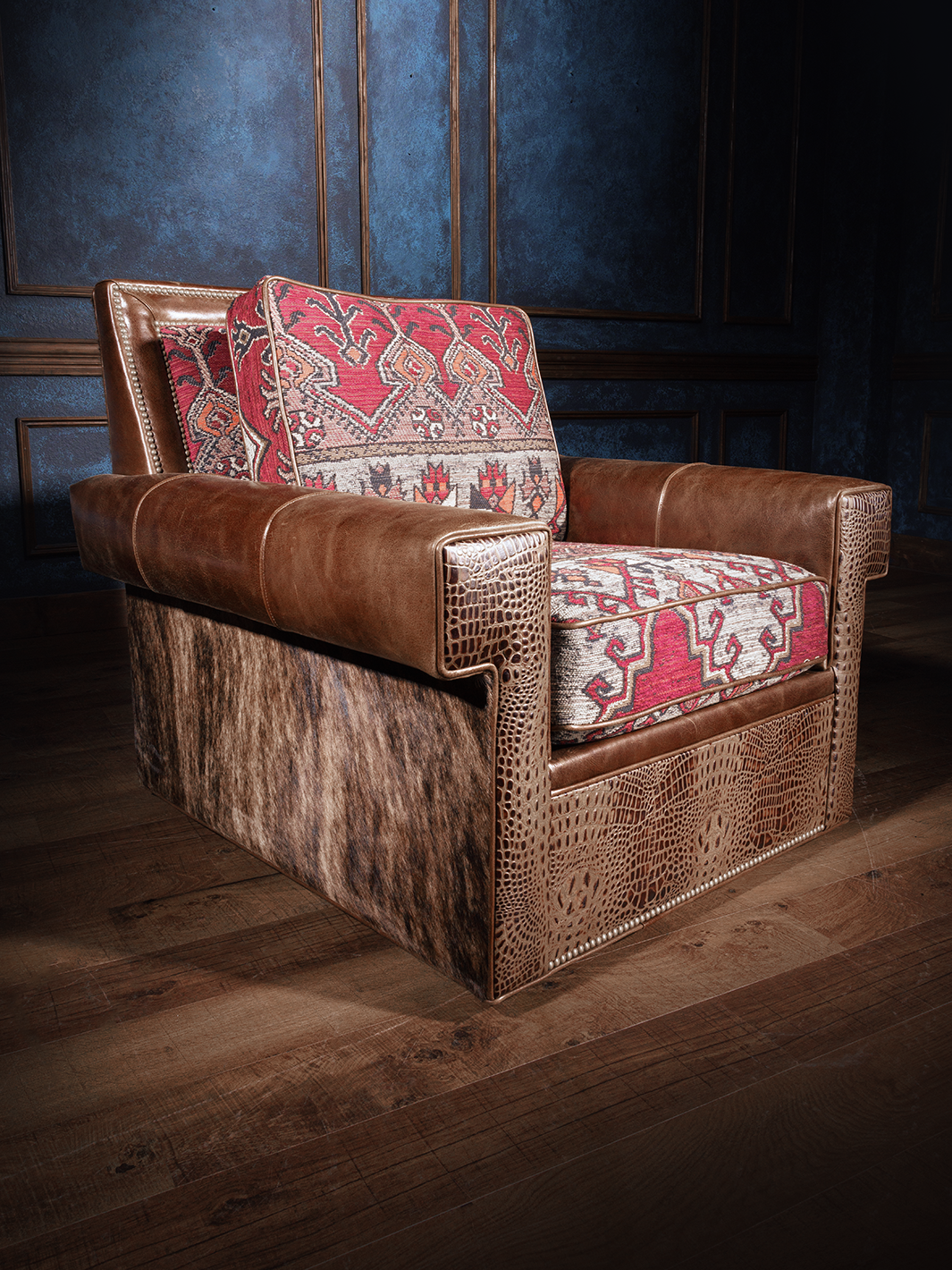 A brown Western Davis Cowhide Swivel Chair with a patterned red and white cushion, placed in a room with blue walls.
