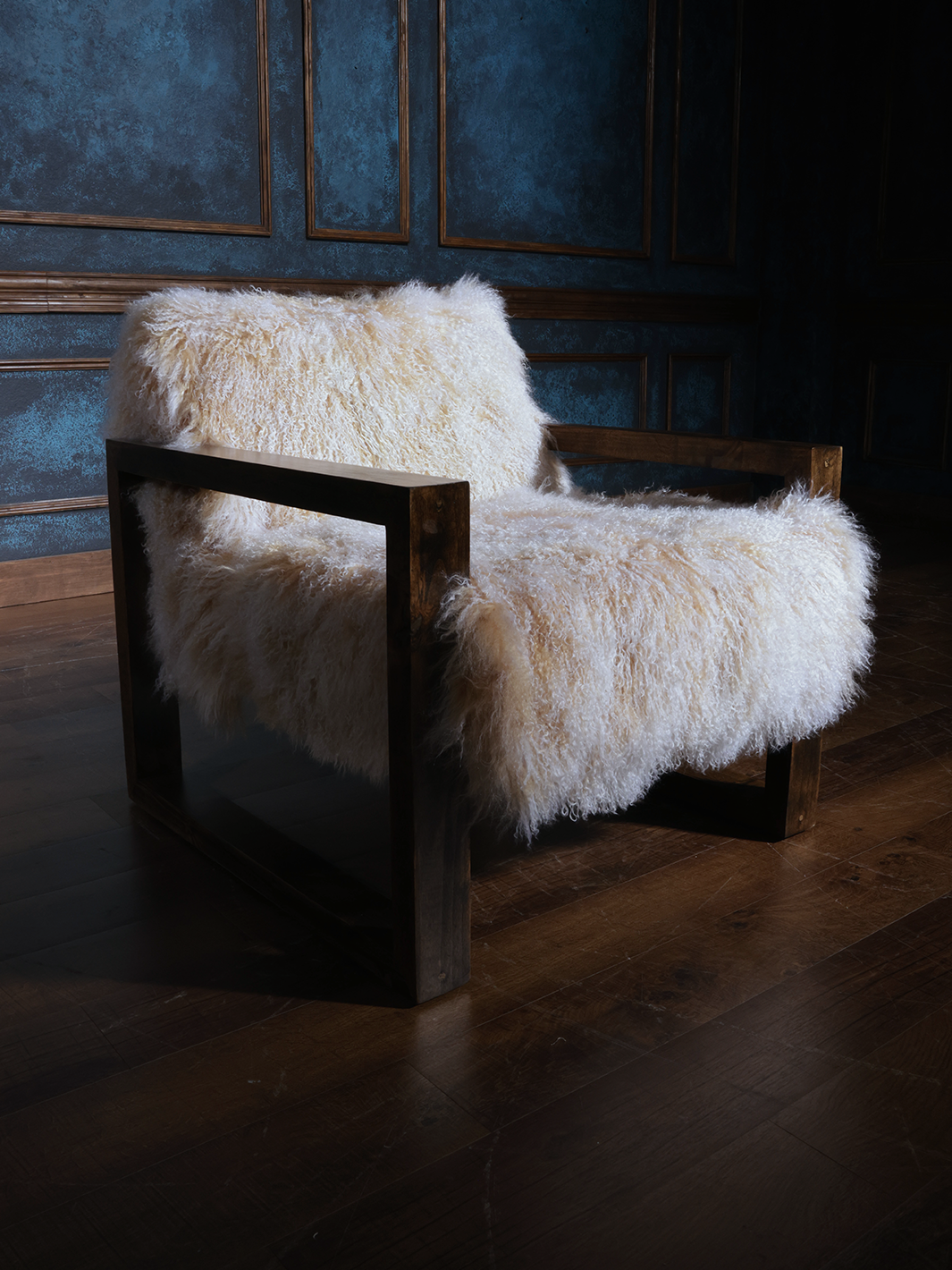 Tibetan wool accent chair featuring a rich wooden box frame and luxuriously soft cream-colored wool covering the seat and backrest. A perfect blend of modern minimalism and rustic texture.