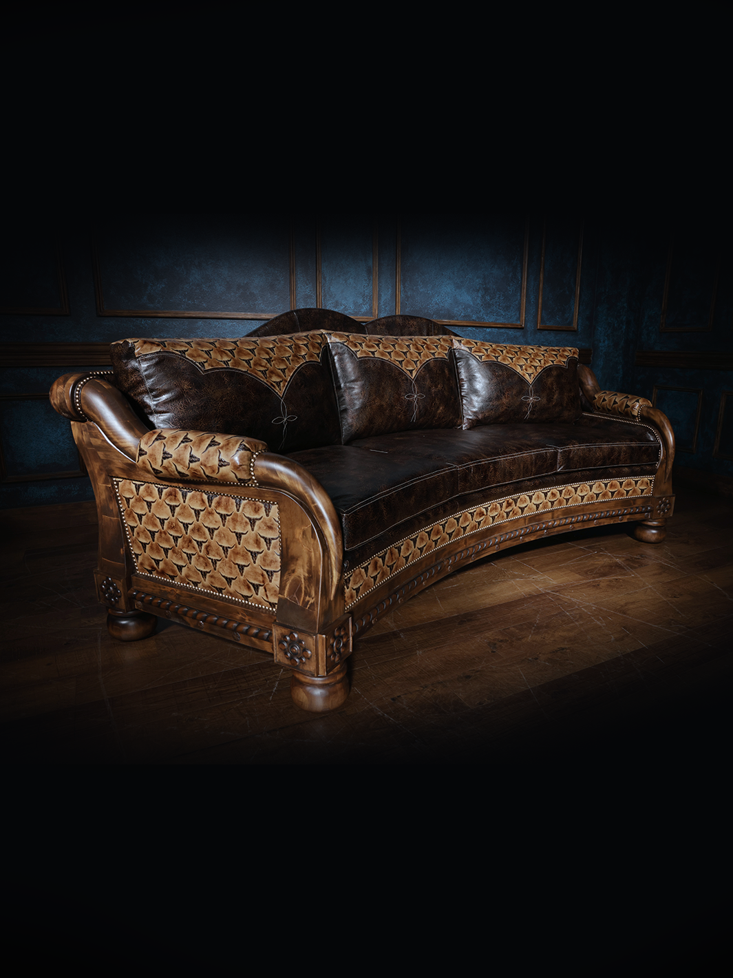 Angled view of a western leather sofa with tooled leather panels and sculpted wood accents, featuring a mix of rich brown tones and rustic textures.