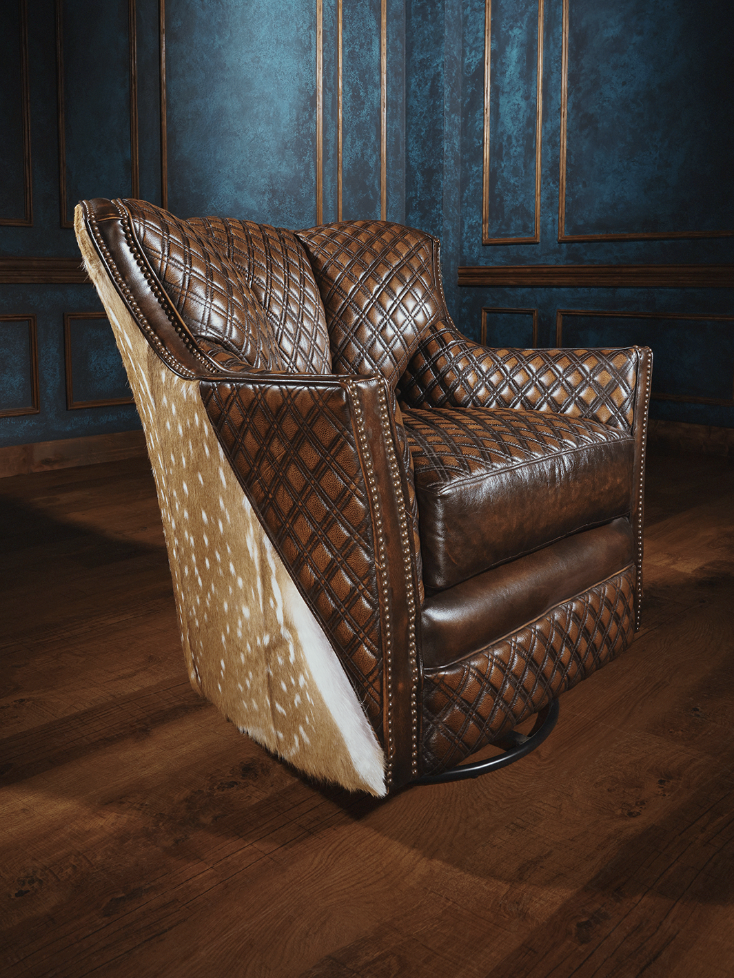 A brown leather swivel chair with a diamond stitch pattern and visible axis hair on hide, set against a blue panelled wall.