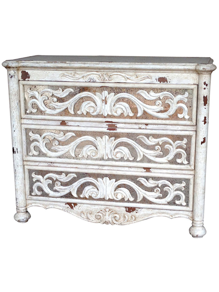 A vintage-style wooden dresser with ornate design and a dark finish, featuring three drawers with intricate details.
