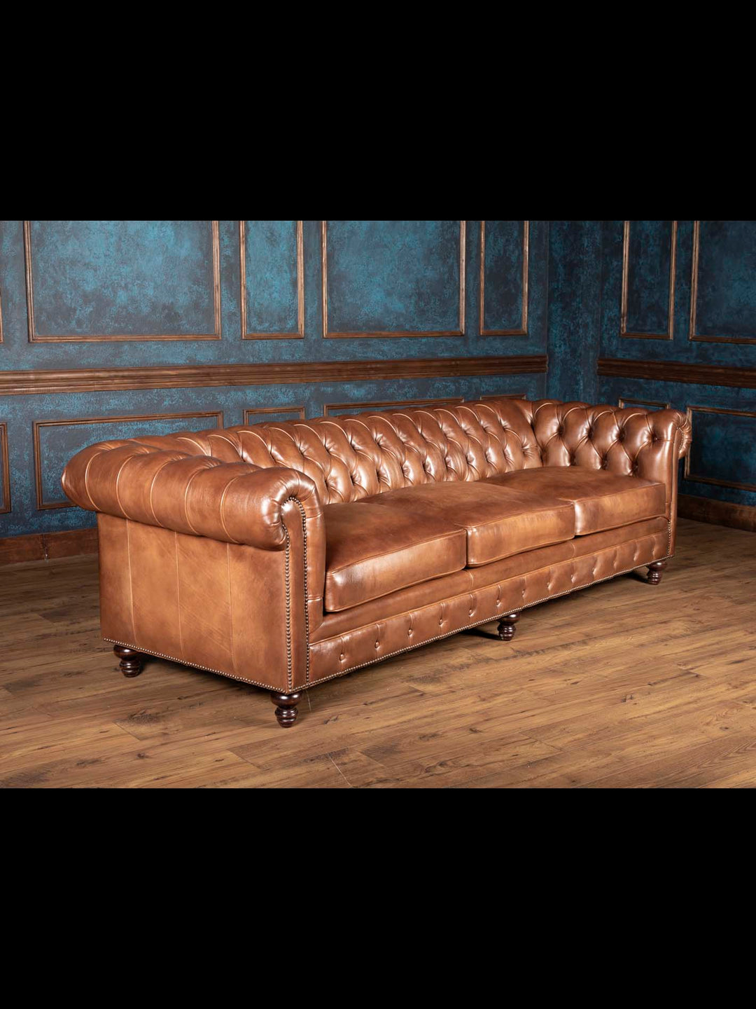 oversized three seat almond leather Chesterfield sofa on wood floor, low back deep seat tufted couch for formal living room