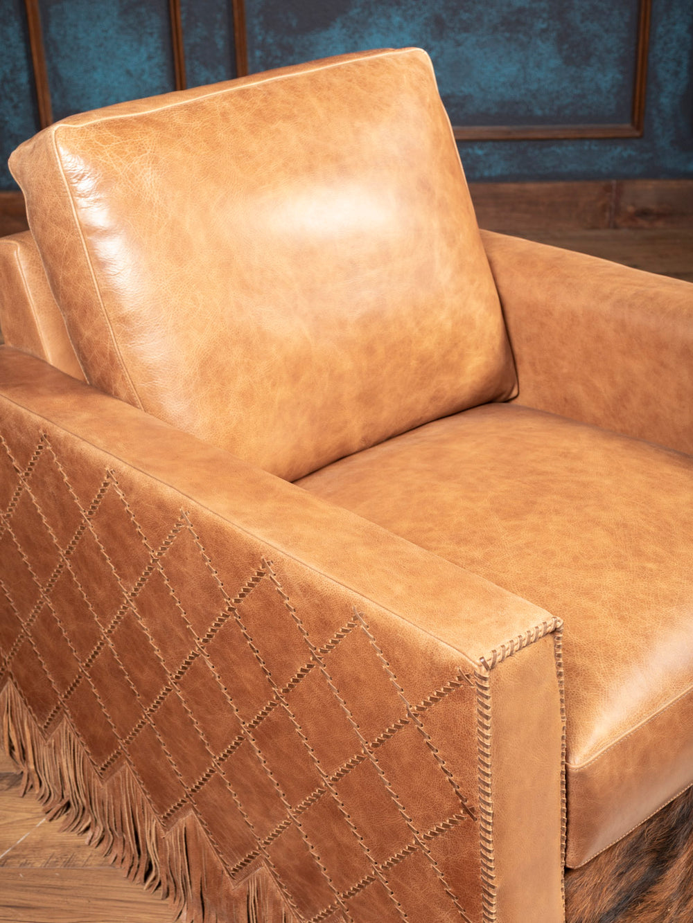 Seat and arm detail of Belmont Laced Leather Swivel Chair in natural tan leather