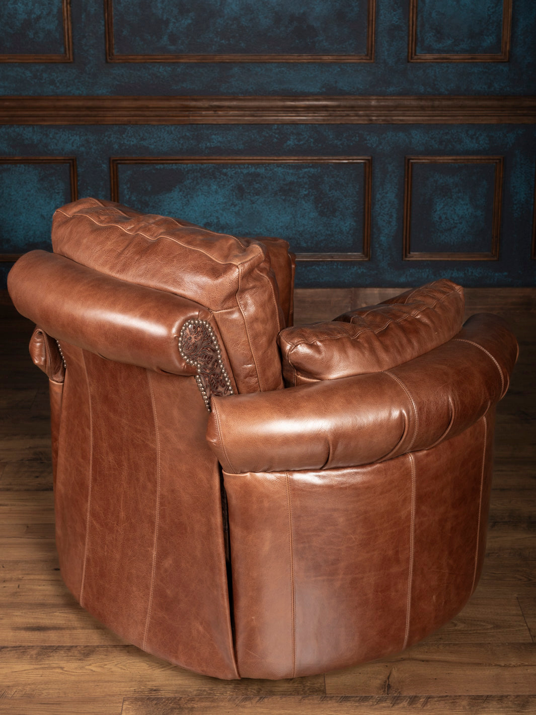 Back view of leather snug recliner with curved silhouette