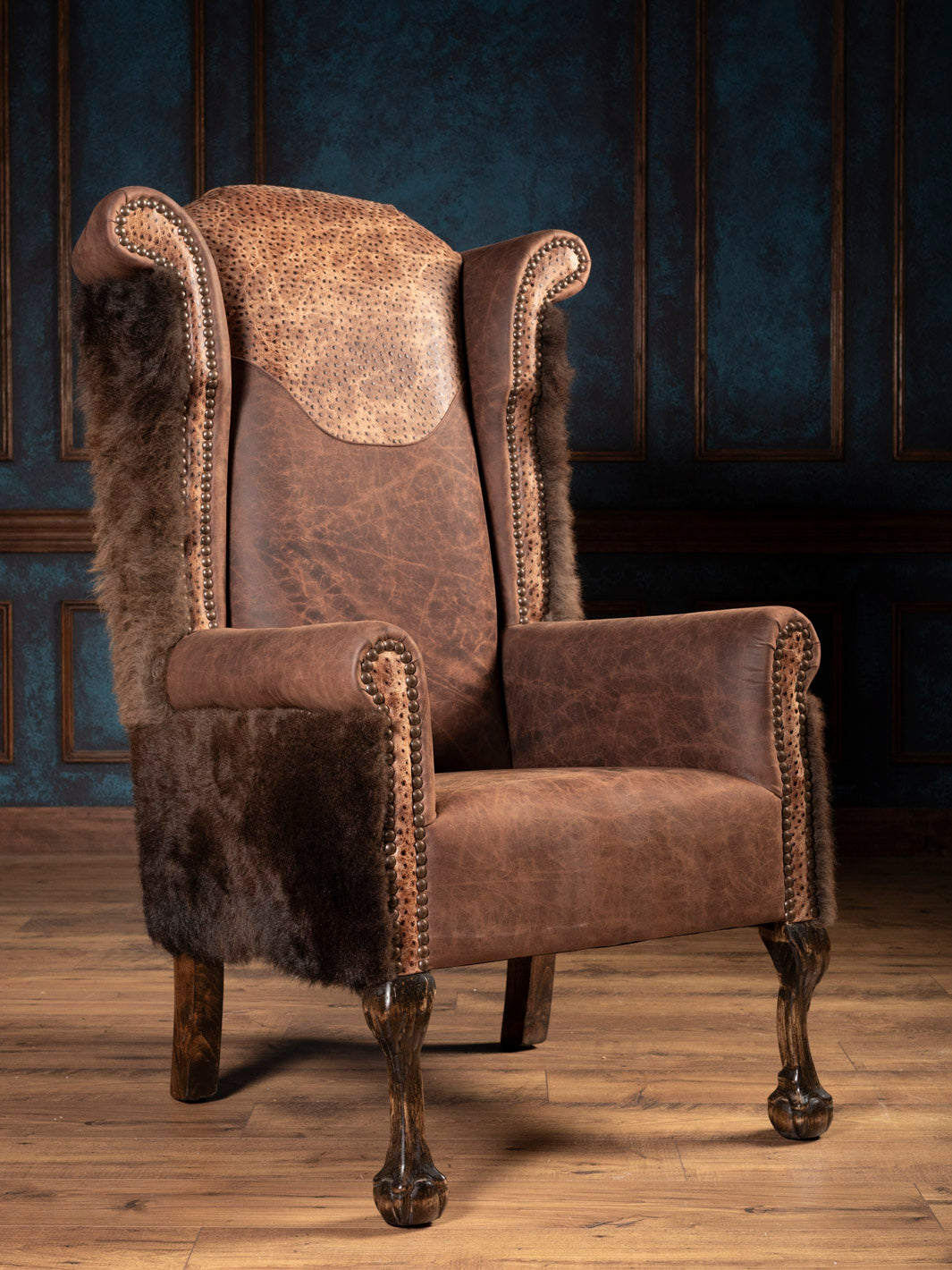 Front angle of the brown leather wingback chair with buffalo hide accent.