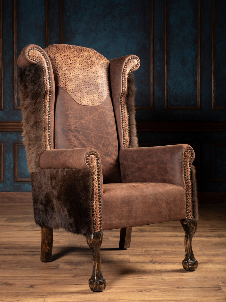 Front angle of the brown leather wingback chair with buffalo hide accent.