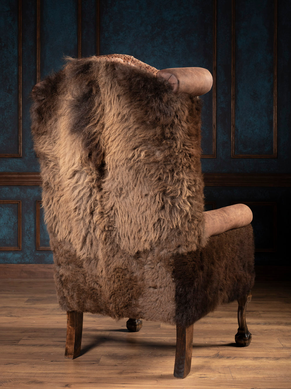 Outside back of brown leather chair with buffalo outside back and arms