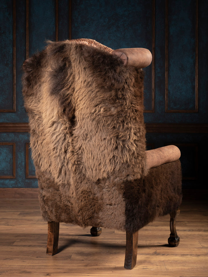 Outside back of brown leather chair with buffalo outside back and arms