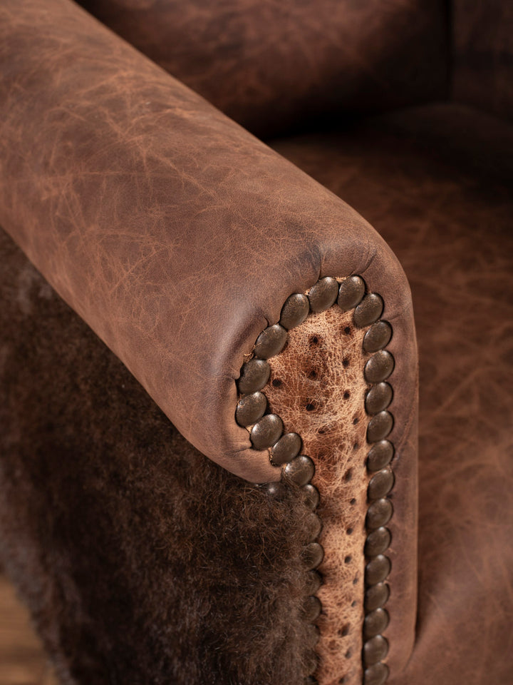 Close up of rolled arm with ostrich inlay and nailheads