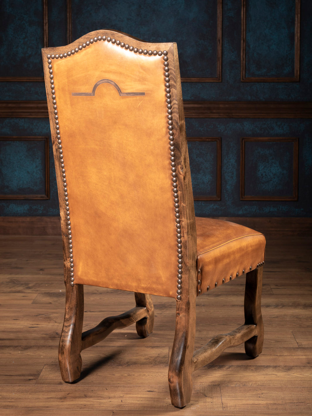 Outside back of brown leather dining chair with laser brand design