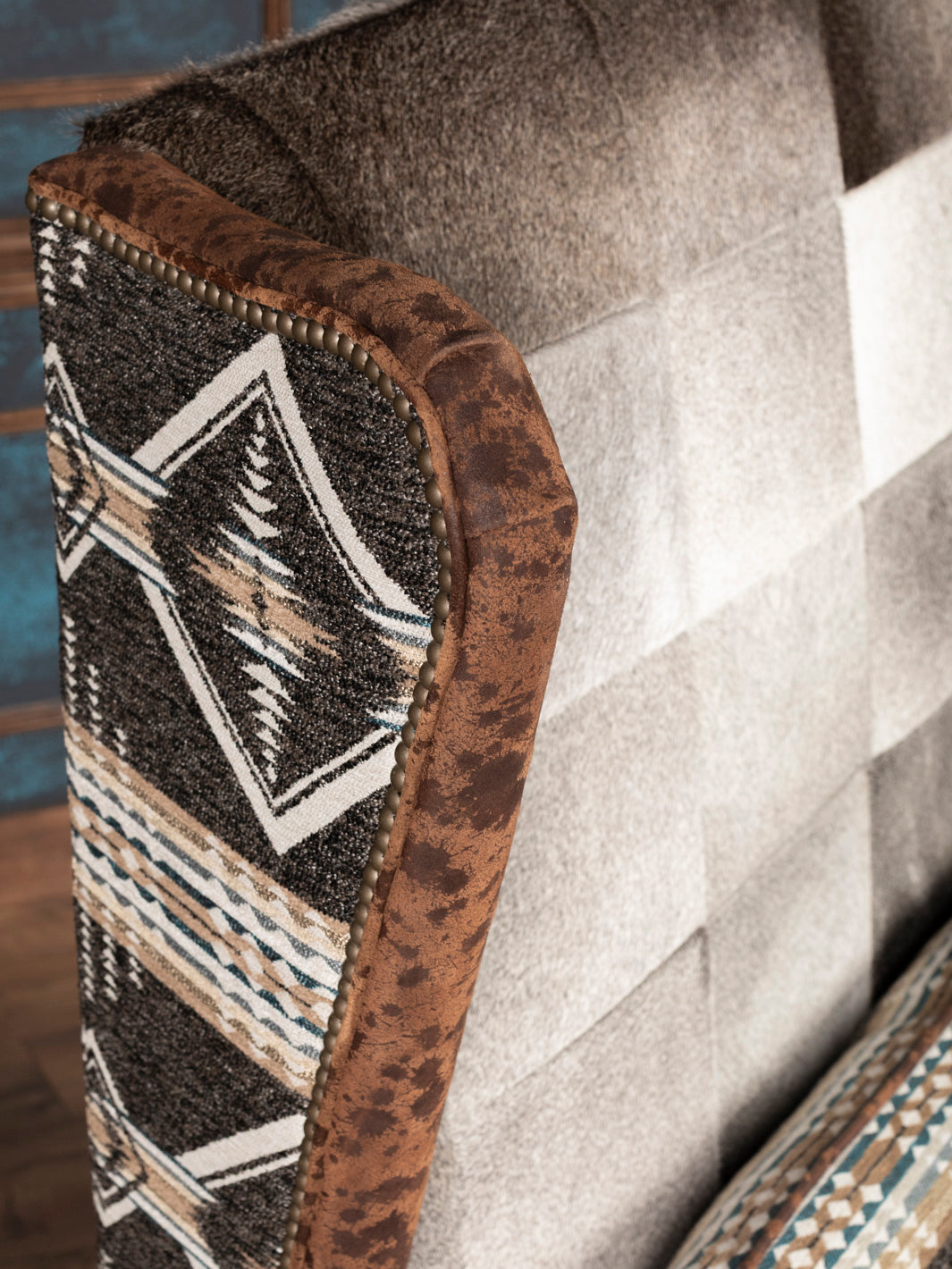 Curved wing with textured brown leather and smooth gray hair-on-hide