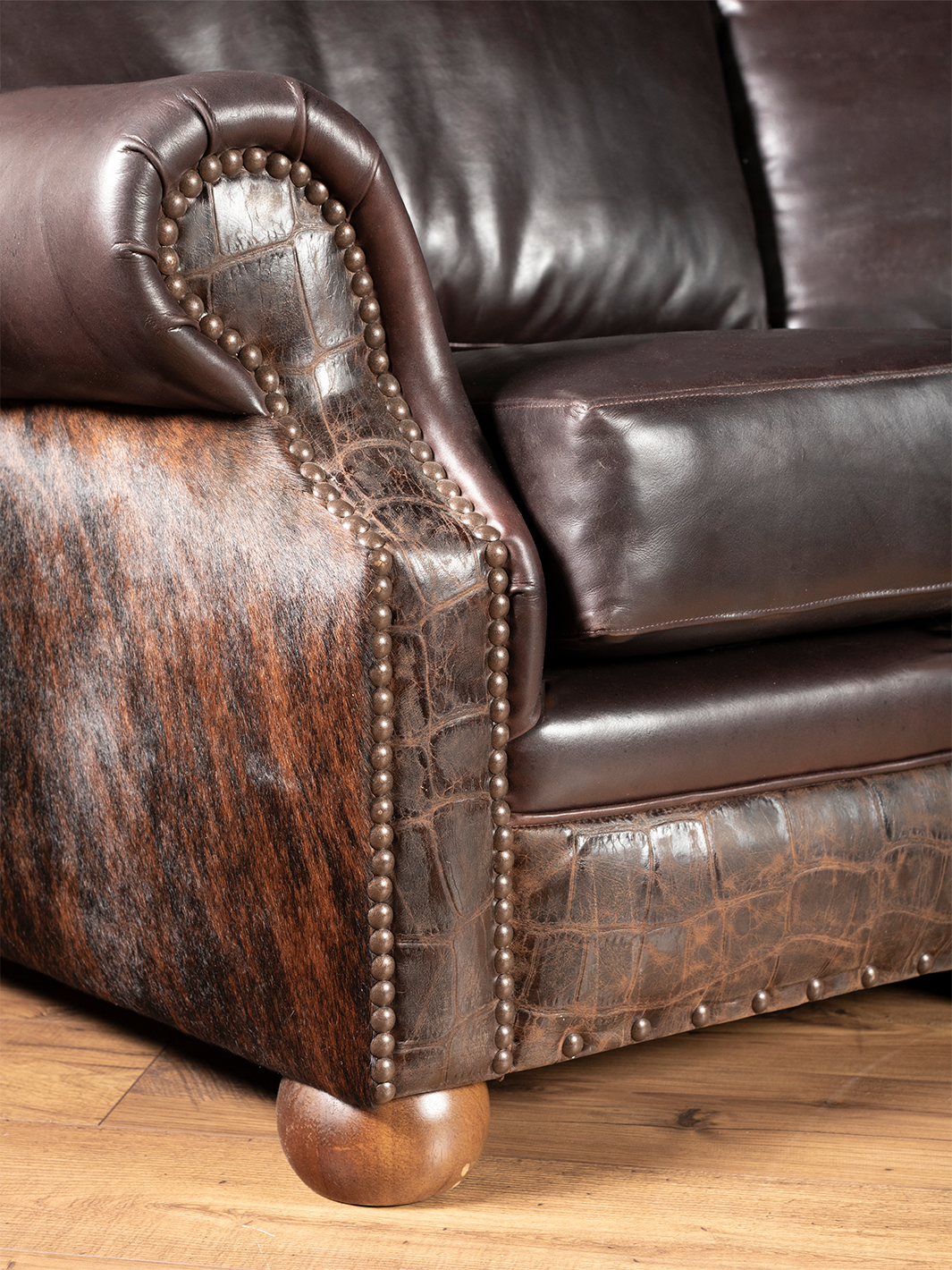 Side view of curved leather sectional with full-grain chocolate leather and croc embossed accents