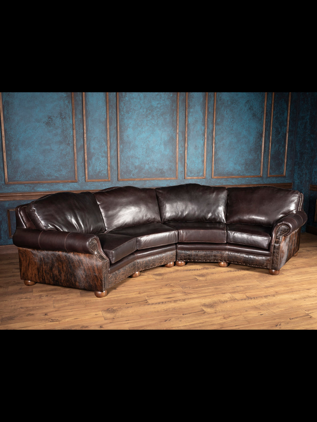 Handcrafted Western leather sectional with cowhide, bun feet, and curved silhouette in brown leather