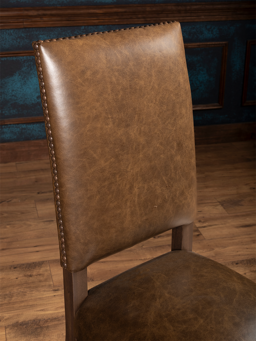 Top-down view of backrest showing stitching and nailhead detailing