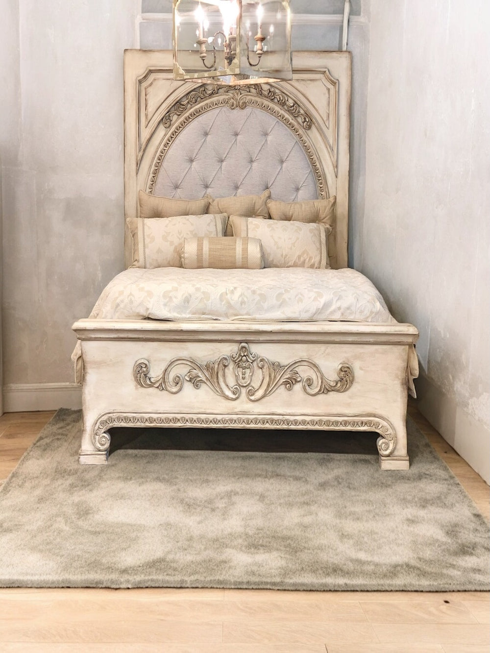 Decorative bed with intricate carvings in a bedroom setting
