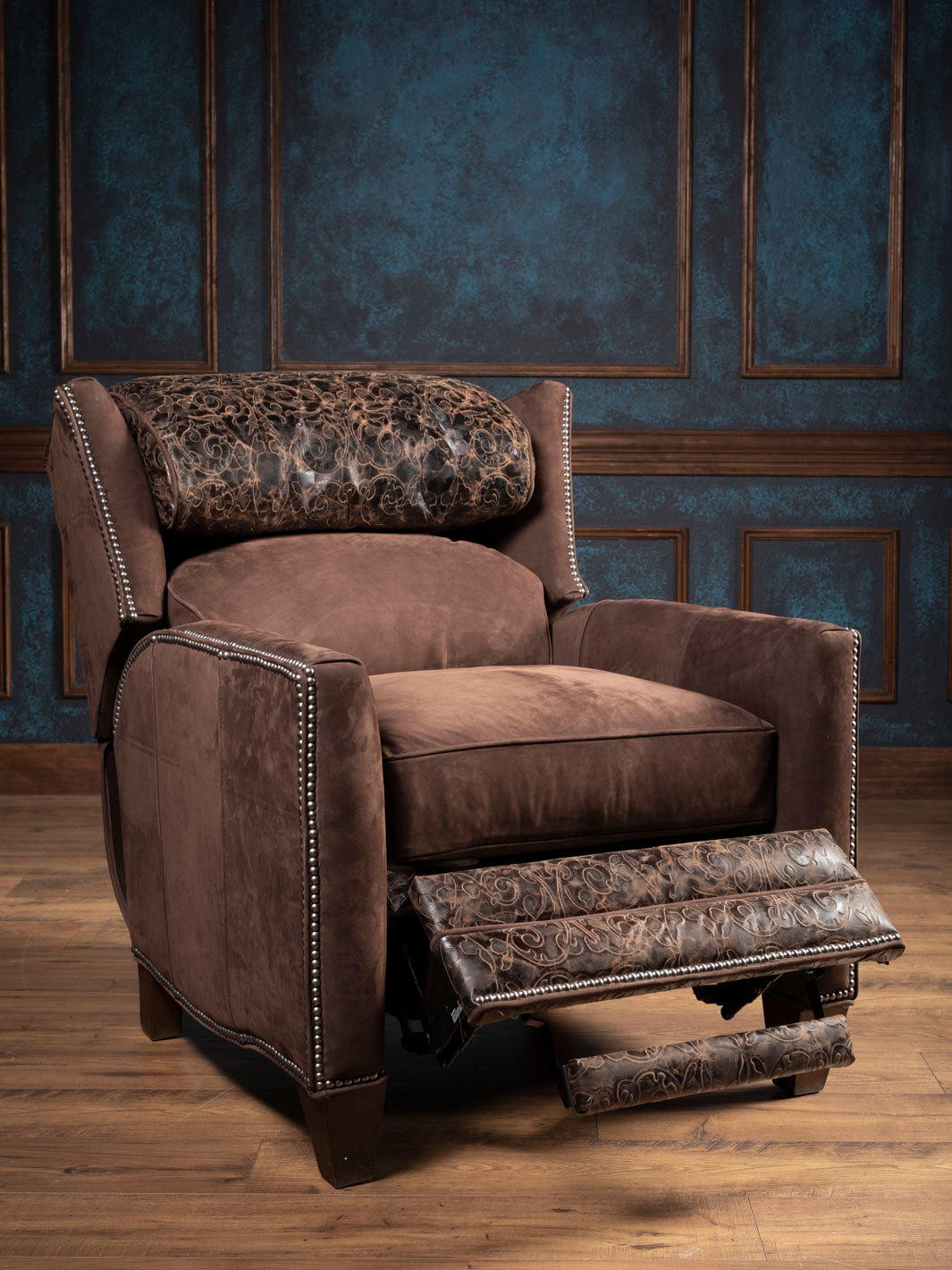 Reclined rustic brown recliner with tooled leather kickplate 