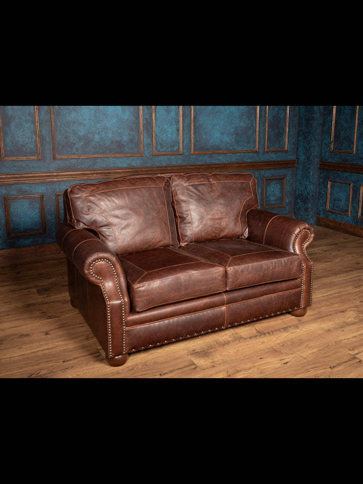 Angled front view of brown leather loveseat
