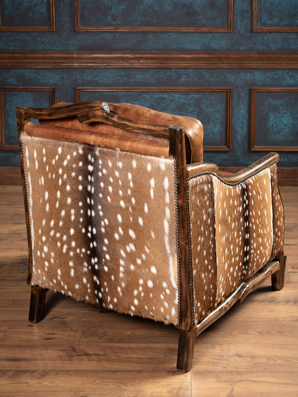 Back view of armchair with genuine axis hide and handcrafted wood frame