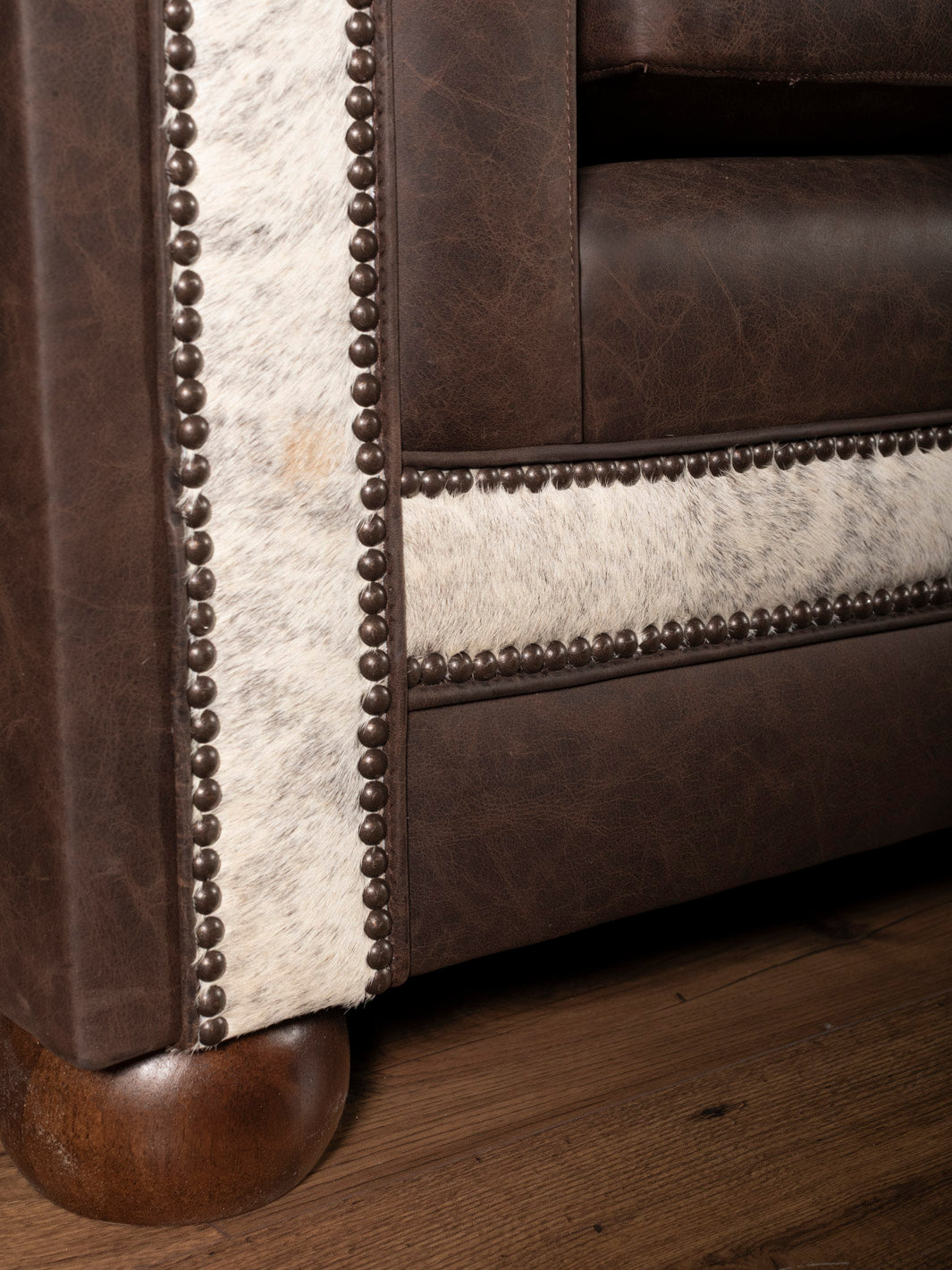 Close up detail shot of leather sofa trim and cowhide contrast on Granite Architect Sofa