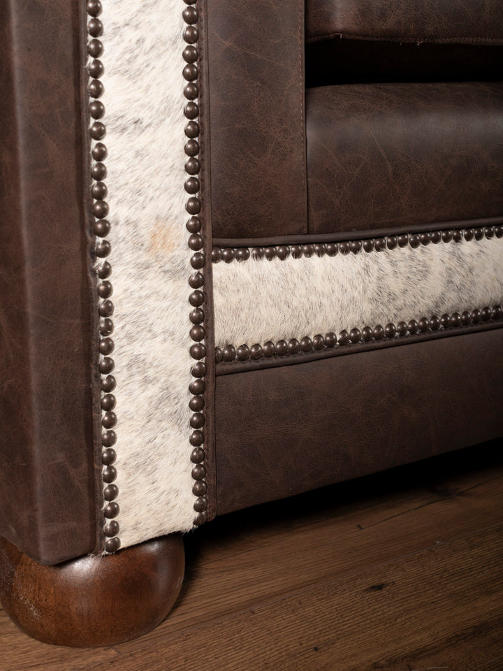 Close up detail shot of leather sofa trim and cowhide contrast on Granite Architect Sofa