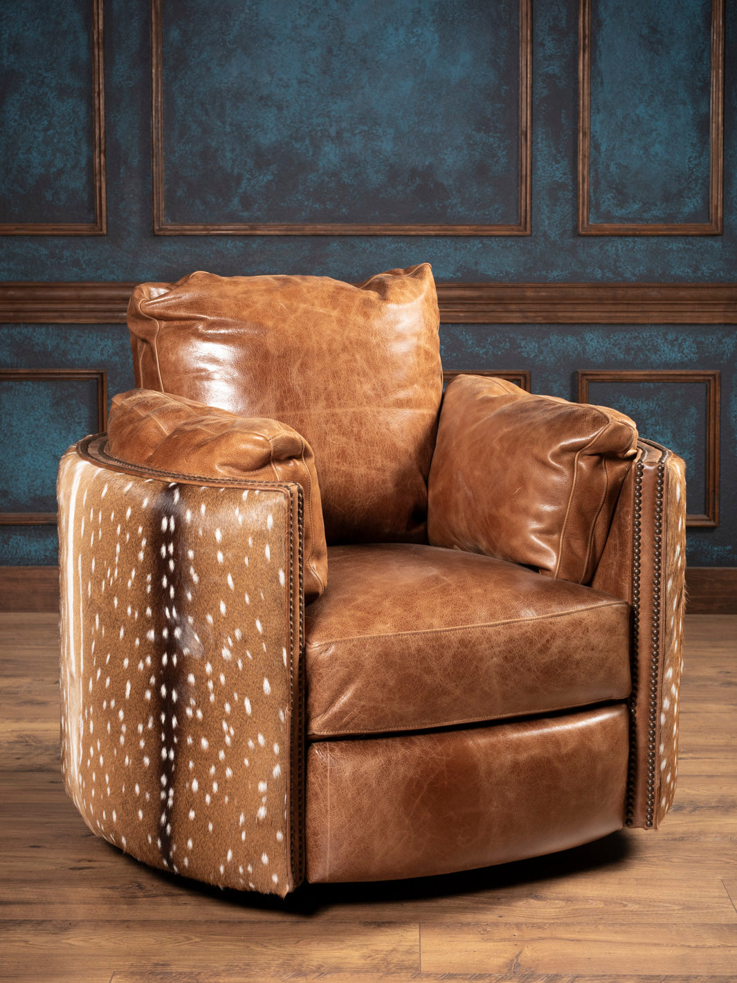 Front View: Luxurious Western swivel recliner featuring top grain leather and axis deer hide.