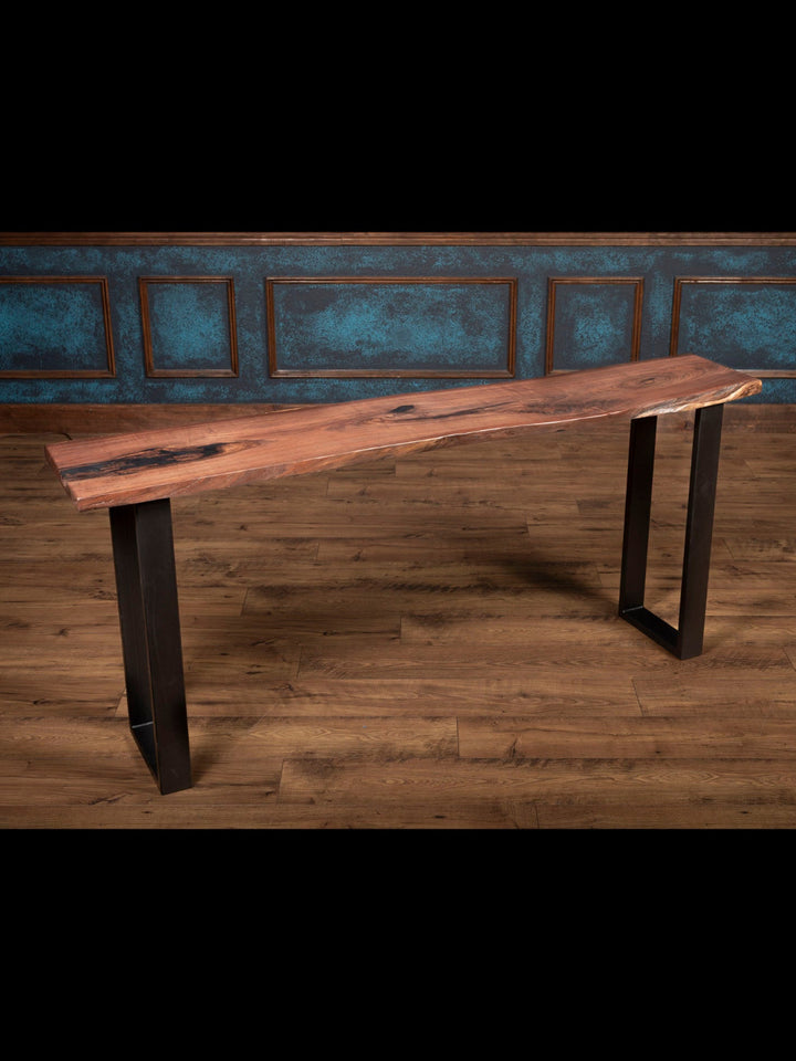 Sofa table with steel leg base and live edge top.