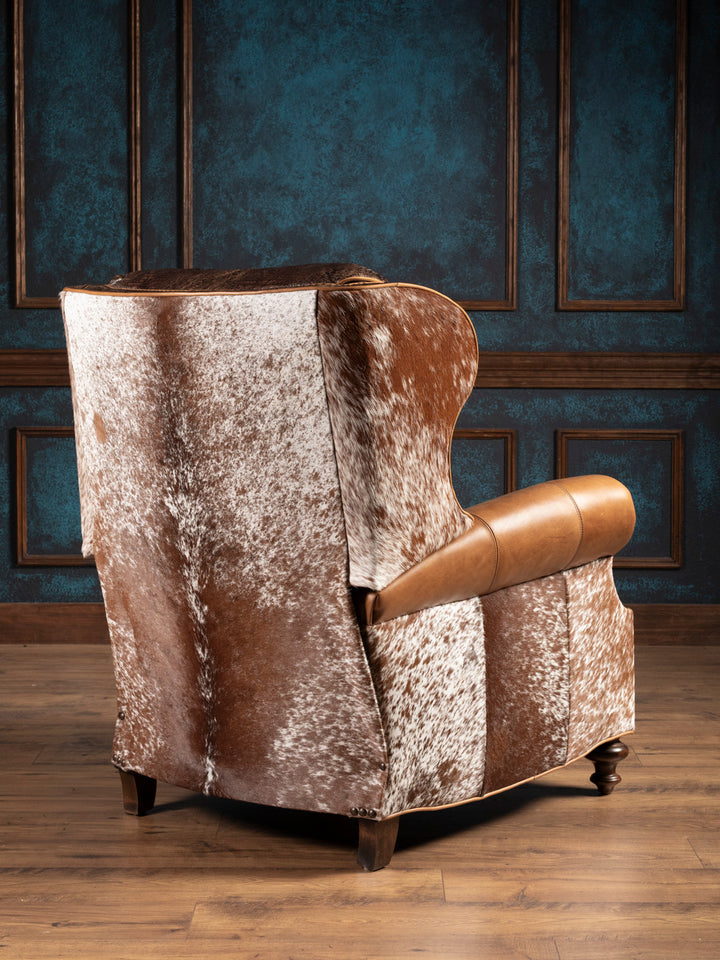 Rear view of Longhorn Leather Bronco Recliner showcasing tri-color hair-on-hide back, saddle leather arm, and curved Western wingback silhouette.