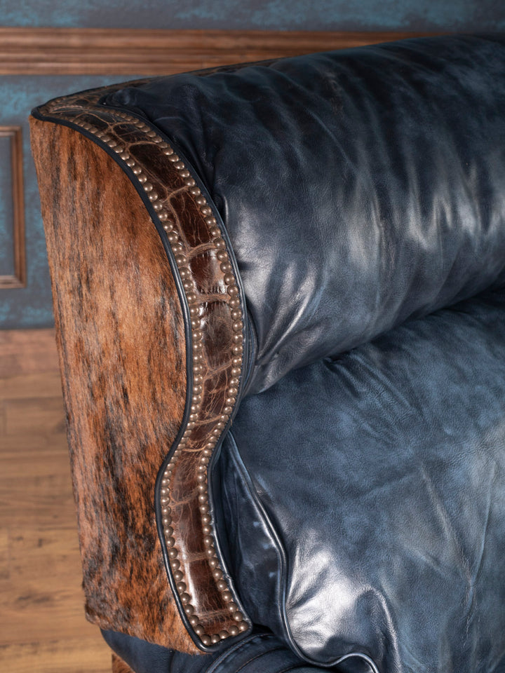 Handcrafted recliner with wingback design, croc-embossed leather trim, cowhide paneling, and blue leather upholstery