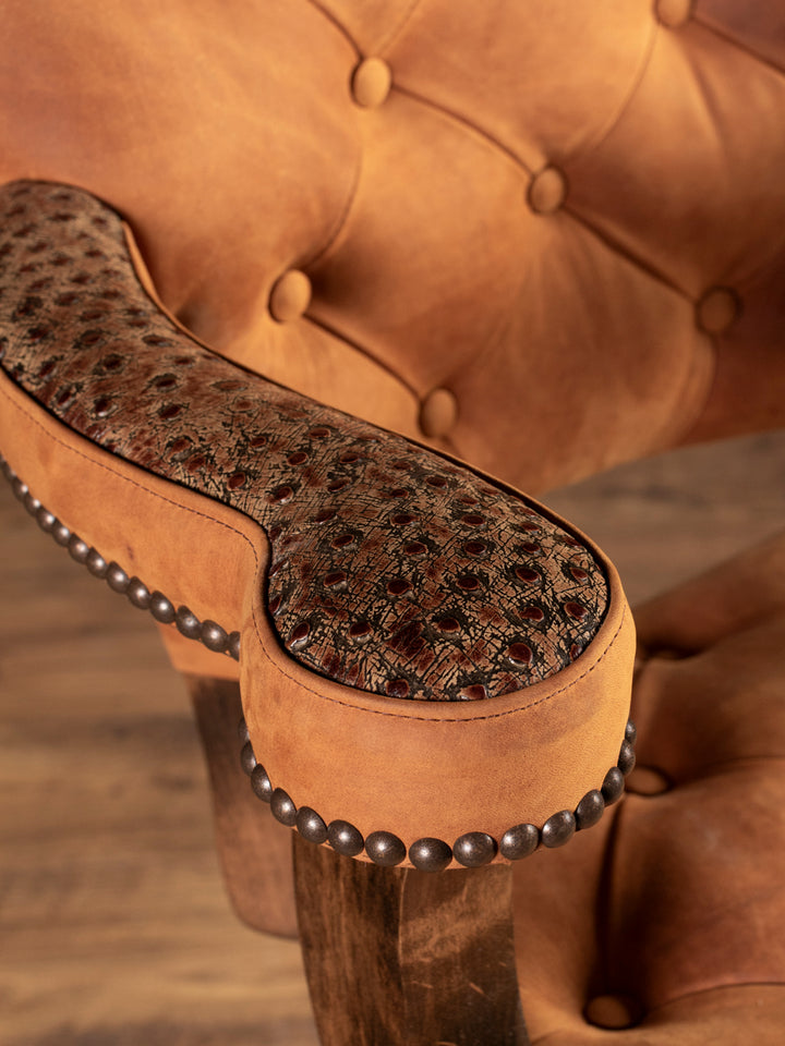 Detail of armrest with ostrich embossed leather and nailhead trim