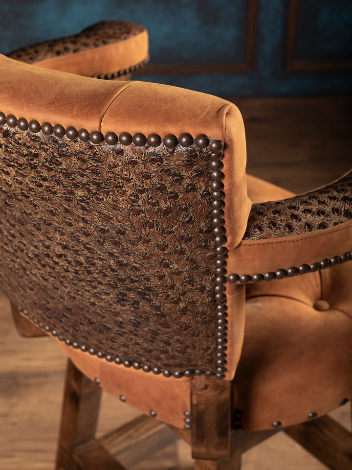 Back panel of ostrich leather bar stool with embossed leather and bronze nailheads