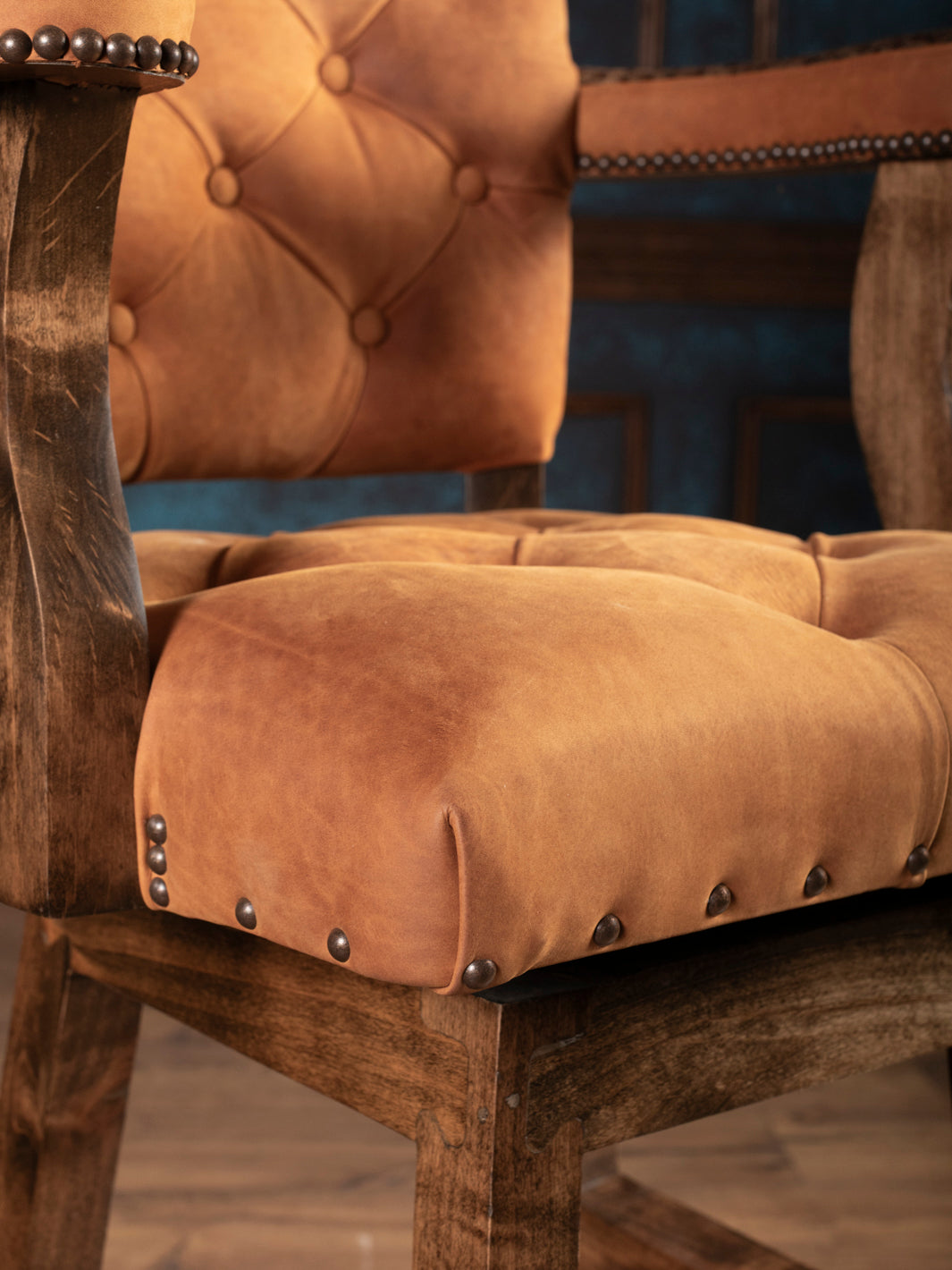 Corner of leather seat with wood frame on ostrich leather bar stool