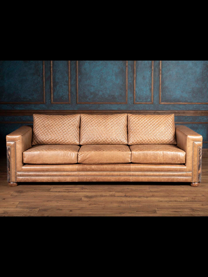 Quilted Cowboy Architect Leather Sofa front view showing tan leather, diamond quilted back cushions and nailhead trim