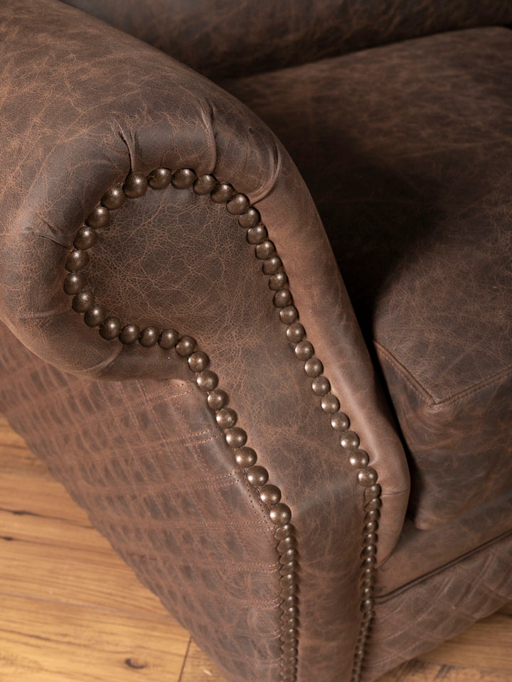 Close up of rolled arm design and antique nailheads