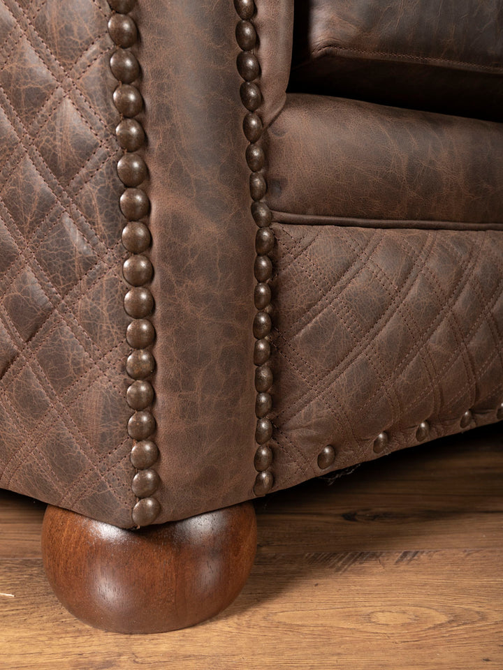 Brown leather sofa and round bun feet