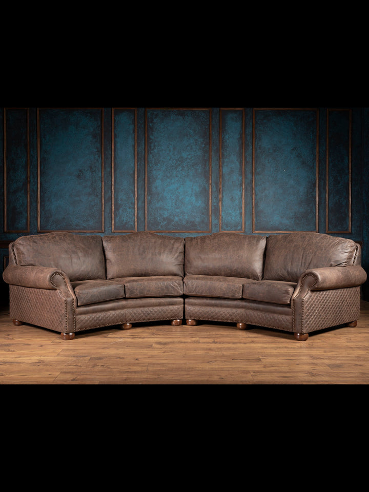 Brown leather sectional sofa with four cushions and diamond quilted accents