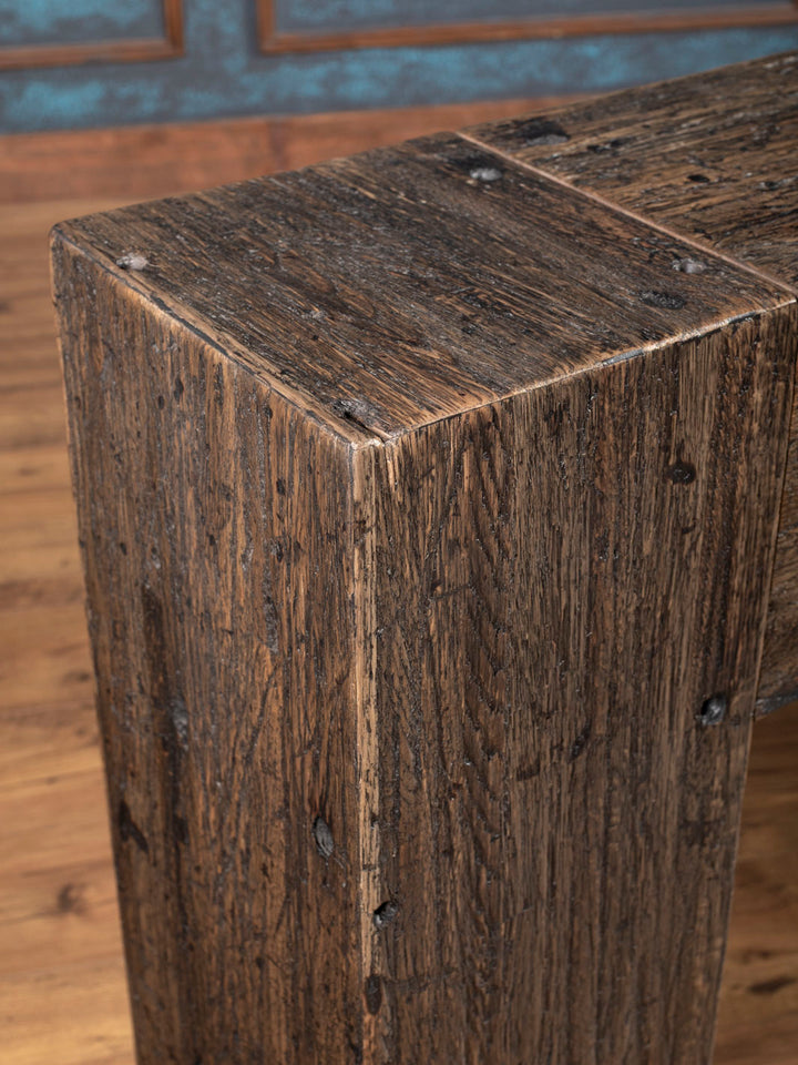 Close-up of a wooden console with a rustic finish.