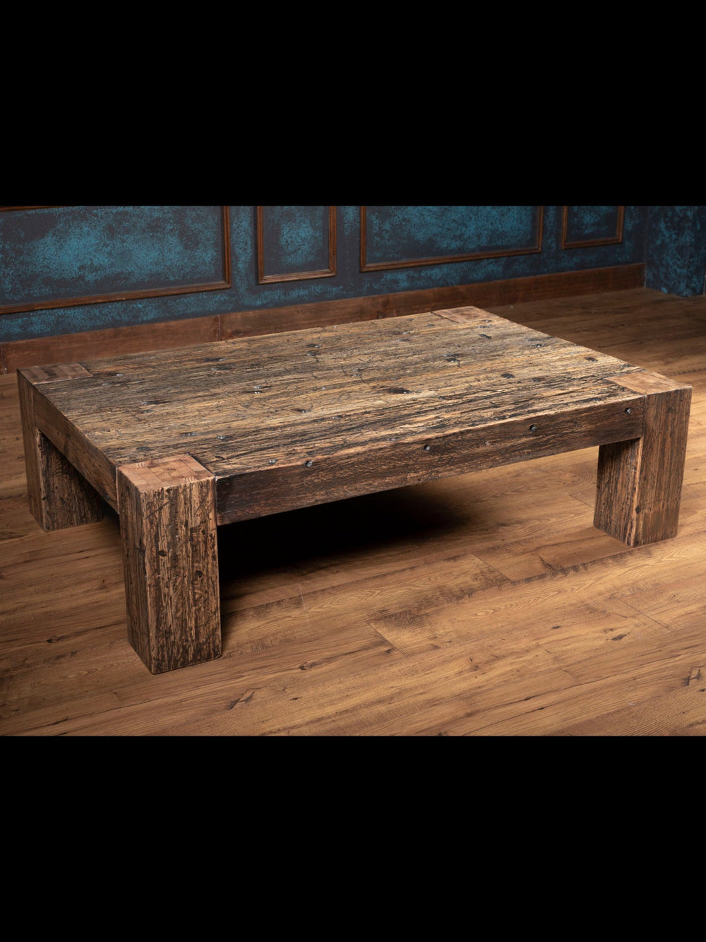 Wooden coffee table with plank legs and heavy distressed detailing. 