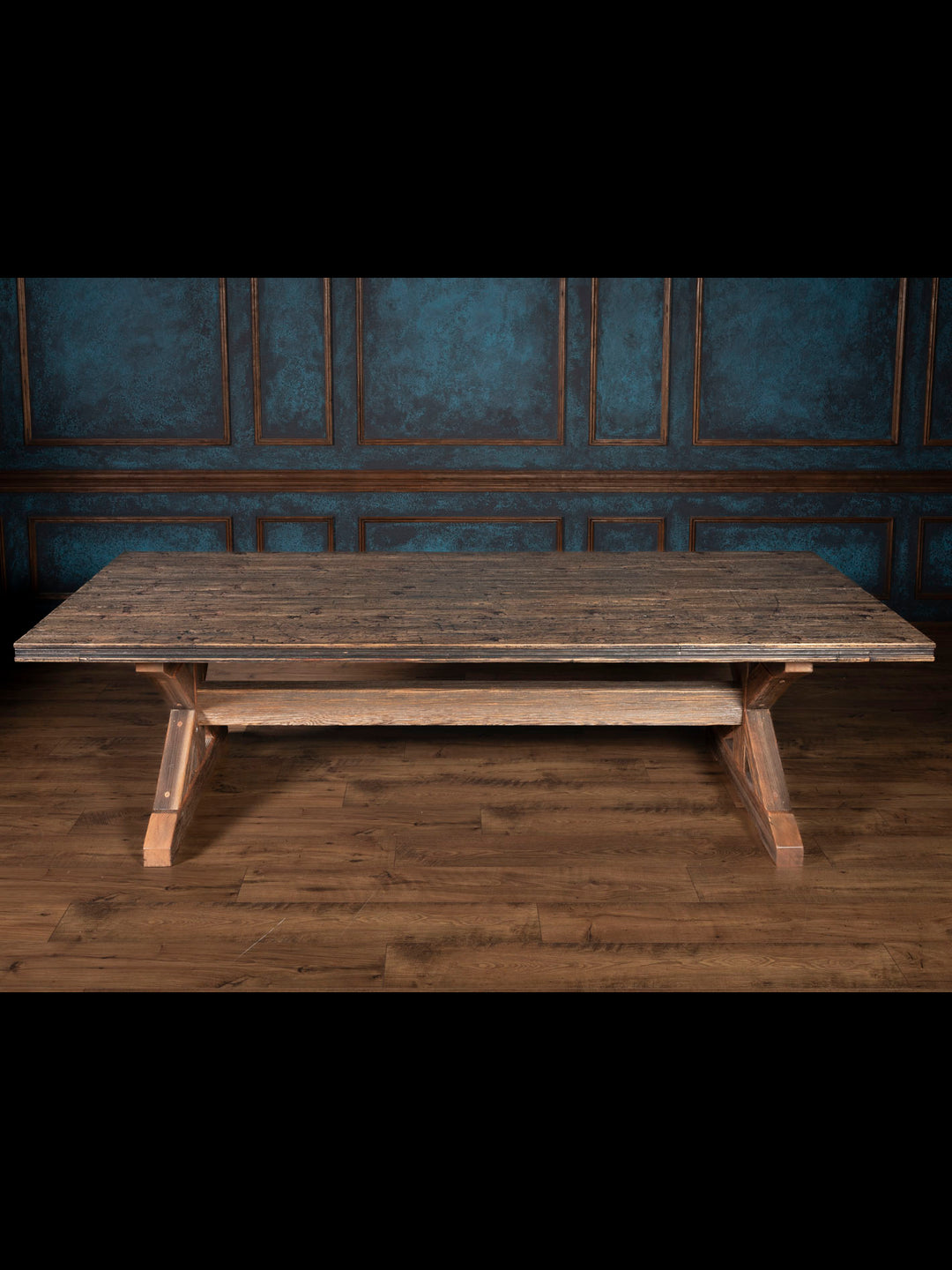 Reclaimed wood dining table with trestle bases.