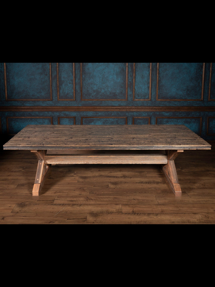 Reclaimed wood dining table with trestle bases.
