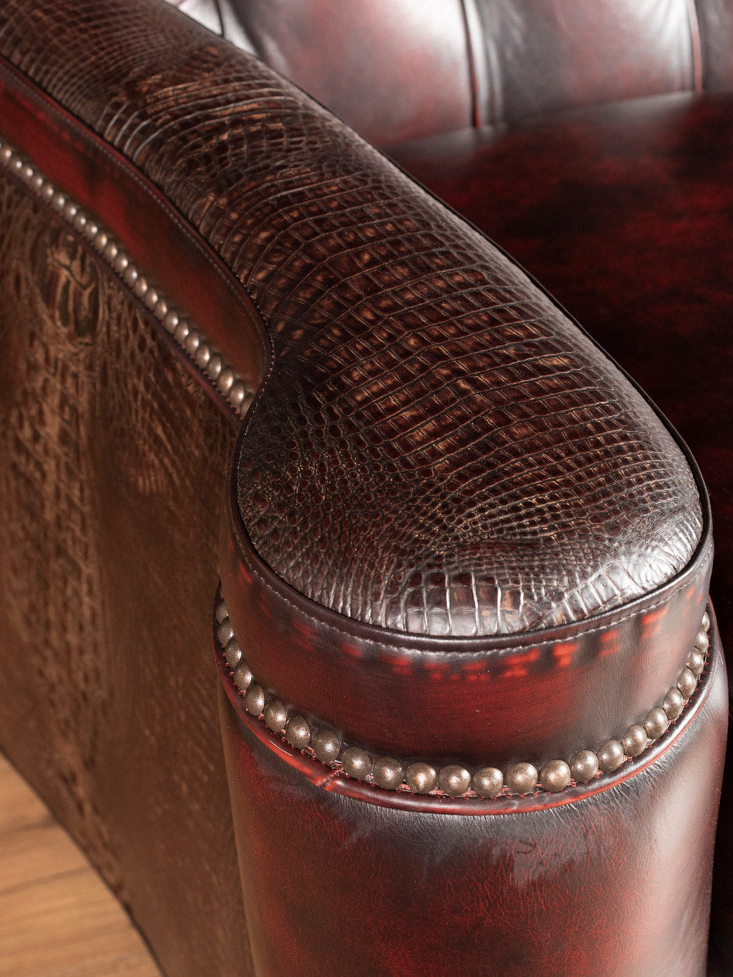 Upclose hand-tufted red leather loveseat with croc leather accents and nailhead trim 