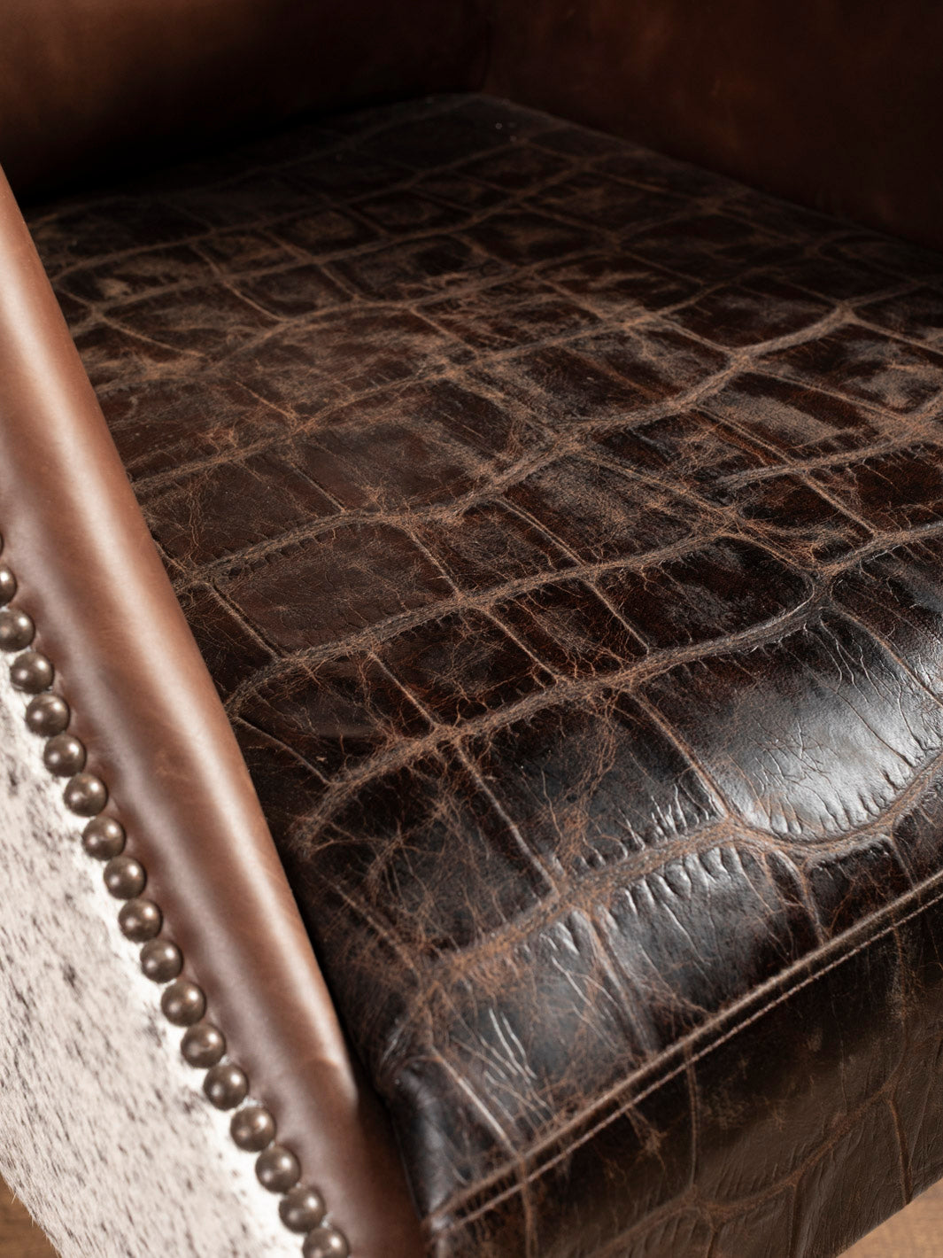 Close-up of a brown gator leather seat cushion