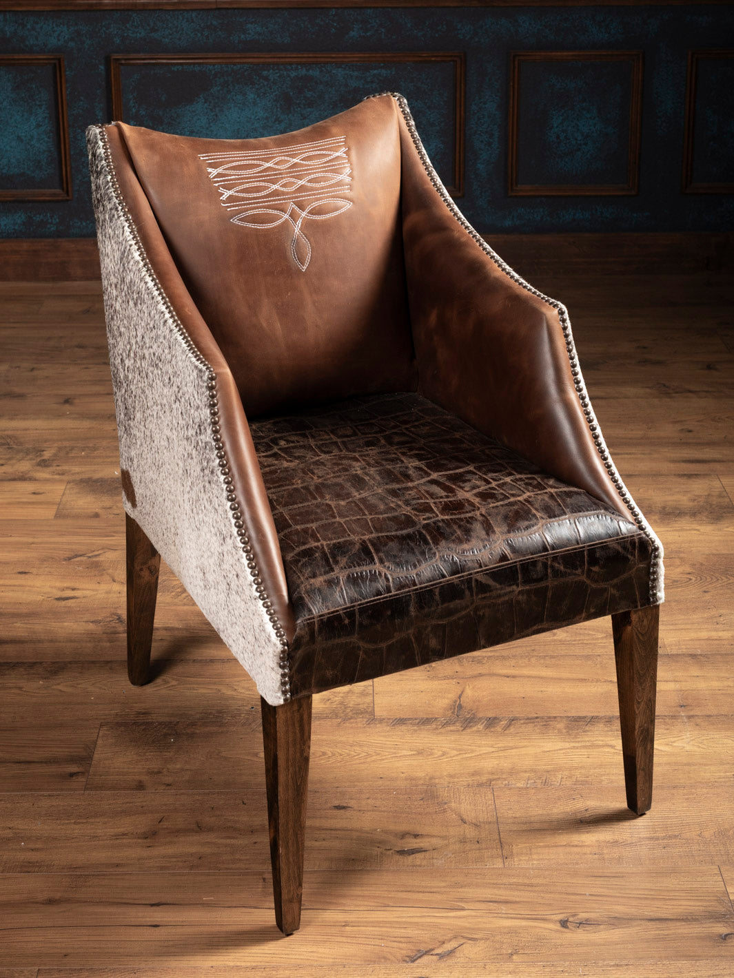 Western Ridgecut arm chair in living room, showing brown leather and cowhide contrast for rustic luxury