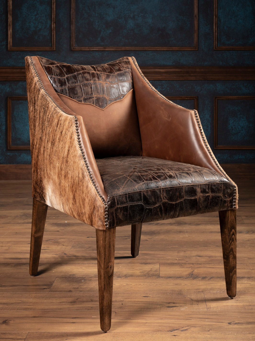 Front angle of brown leather chair with stamped gator leather and brown cowhide outside. 