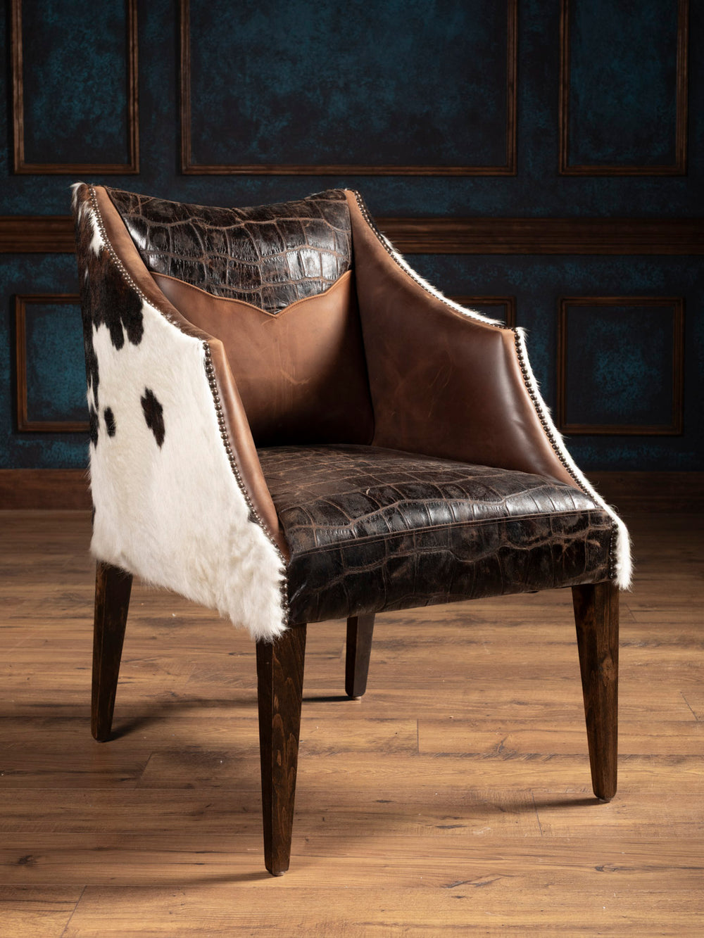 Front angle of brown leather chair with stamped gator leather and tri color cowhide outside. 