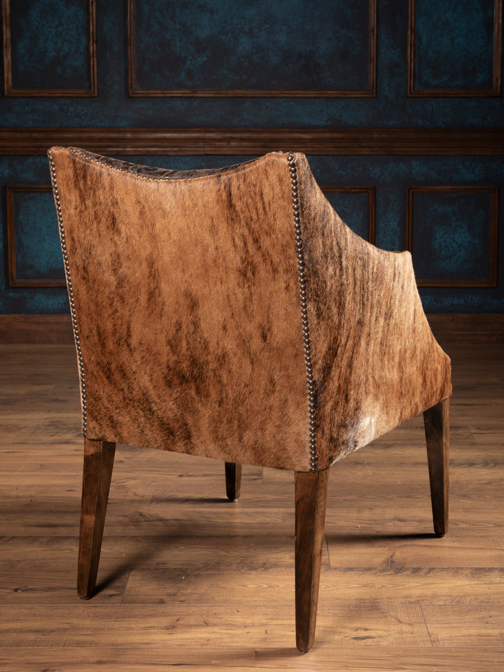 Outside back of brown leather chair featuring brown cowhide back and arms
